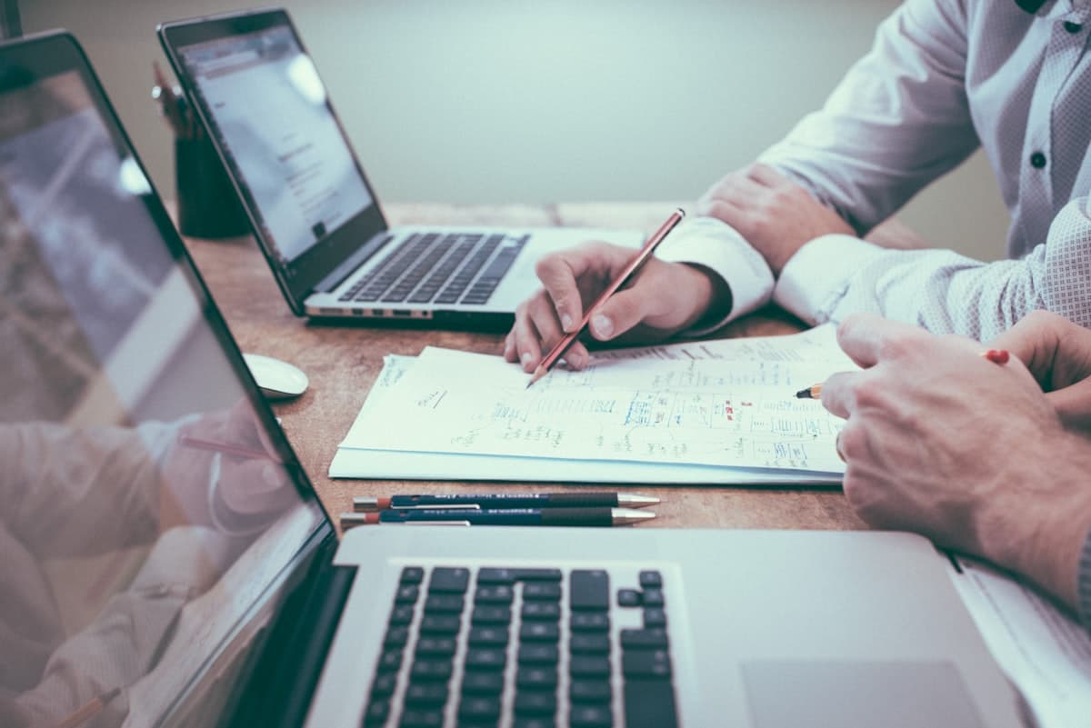 Professional working at a desk with laptop and documents
