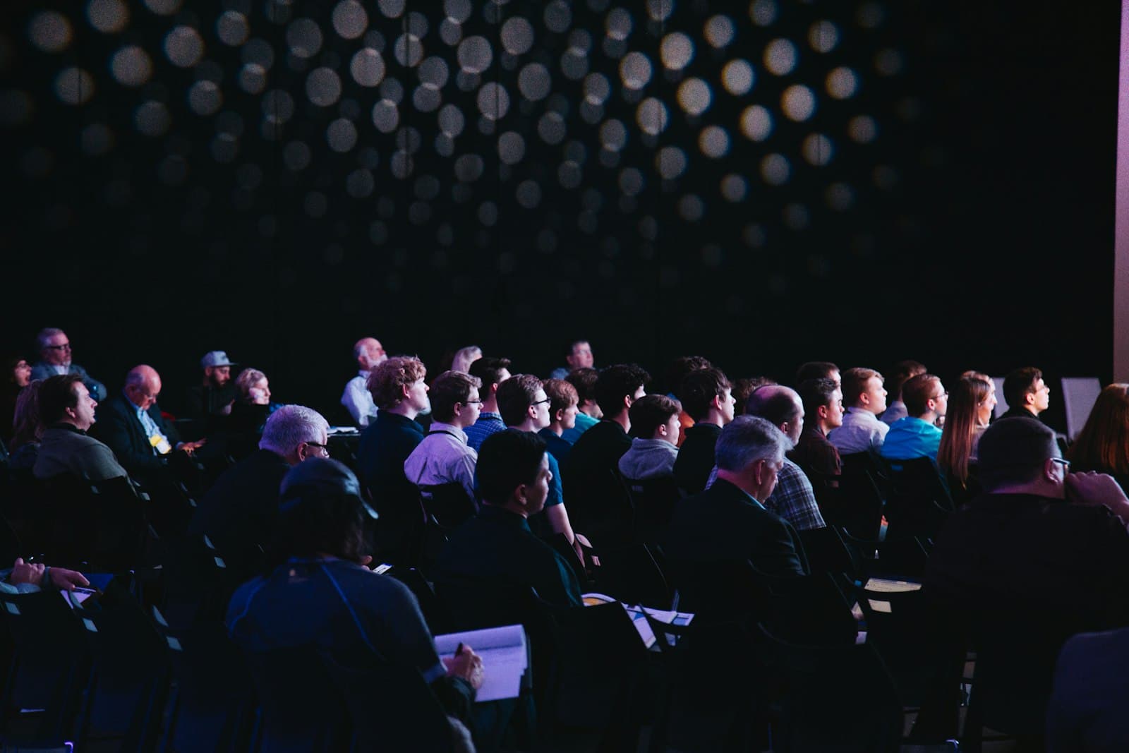 Professionals collaborating at a conference or corporate event with multilingual communication.